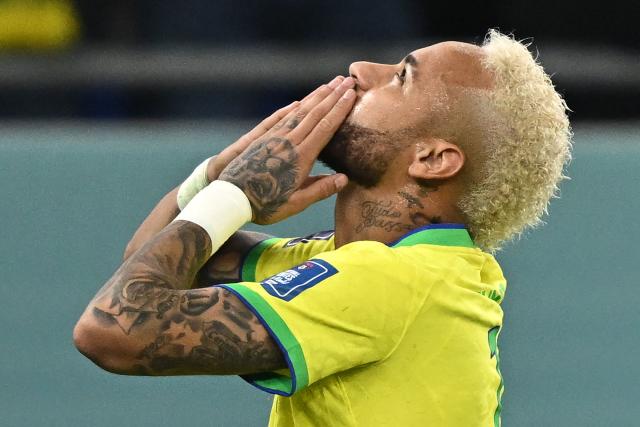 (FILES) Brazil's forward #10 Neymar celebrates scoring his team's second goal from the penalty spot during the Qatar 2022 World Cup round of 16 football match between Brazil and South Korea at Stadium 974 in Doha on December 5, 2022. Brazil superstar Neymar was handed a dramatic recall to the country's World Cup squad on May 18, 2026, returning to the national team after a near three-year absence. (Photo by MANAN VATSYAYANA / AFP)