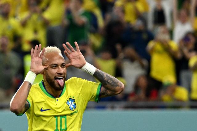 (FILES) Brazil's forward #10 Neymar celebrates scoring his team's second goal from the penalty spot during the Qatar 2022 World Cup round of 16 football match between Brazil and South Korea at Stadium 974 in Doha on December 5, 2022. Brazil superstar Neymar was handed a dramatic recall to the country's World Cup squad on May 18, 2026, returning to the national team after a near three-year absence. (Photo by Pablo PORCIUNCULA / AFP)