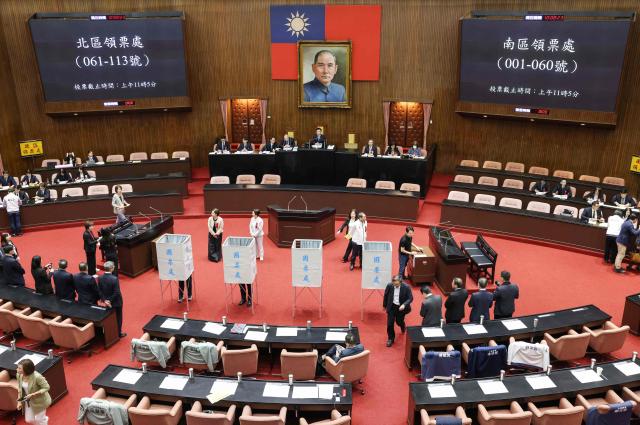 Members of Taiwan's opposition parties 'KMT' and 'Taiwan People's Party' vote on an impeachment motion against President Lai Ching-te at Legislative Yuan chamber in Taipei on May 19, 2026. (Photo by I-Hwa Cheng / AFP)