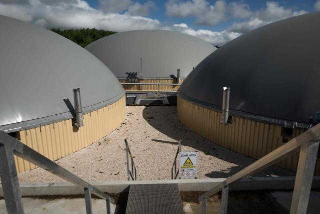 This photograph shows a view of concrete vats at the biomethane plant of Blajan, south-western France on May 18, 2026. The Blajan plant processes some 27,000 tonnes of biomass each year, and 20 MWh of biomethane are injected into the French natural gas providor (GRDF) network, equivalent to the consumption of a town of 12,000 inhabitants. (Photo by Ed JONES / AFP)