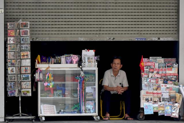 A man looks out from a grocery store in Hanoi on May 19, 2026. (Photo by Nhac NGUYEN / AFP)