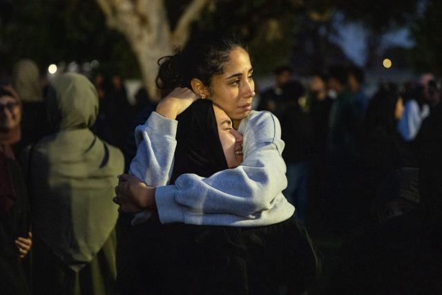 Community members embrace following a vigil for victims and families of a shooting at the Islamic Center of San Diego in San Diego, California, on May 19, 2026, a day after the attack. A shooting at a mosque complex in California on May 18, 2026 killed three people, with two suspected teenage gunmen later found dead in a car from self-inflicted gunshot wounds, police said. (Photo by Zoë Meyers / AFP)