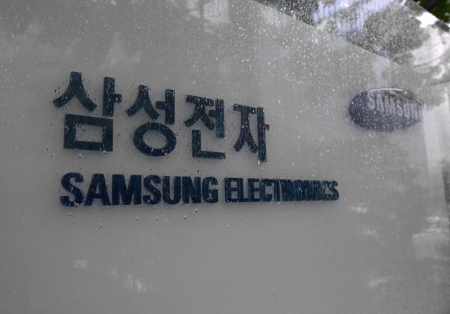 Signage of Samsung Electronics is displayed outside the company's Seocho building in Seoul on May 20, 2026. A planned strike at South Korean chip giant Samsung Electronics will go ahead from May 21, its union said, after talks on bonus payouts collapsed, raising concerns over a disruption to the country's key semiconductor industry. (Photo by Jung Yeon-je / AFP)