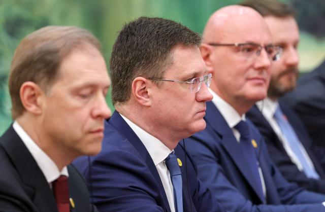 In this pool photograph distributed by the Russian state agency Sputnik, Russia's Deputy Prime Minister Alexander Novak (2nd-L) attends a meeting with Russian President Vladimir Putin (not pictured) and China's President Xi Jinping (not pictured) in Beijing on May 20, 2026. (Photo by Alexander KAZAKOV / POOL / AFP)