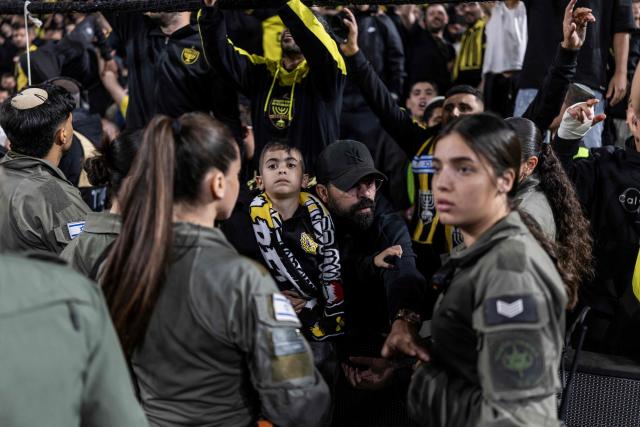 Police block Beitar Jerusalem fans from entering the pitch at the end of the match against Hapoel Tel Aviv at Bloomfield Stadium in Tel Aviv on May 6, 2026. (Photo by Ilia YEFIMOVICH / AFP)