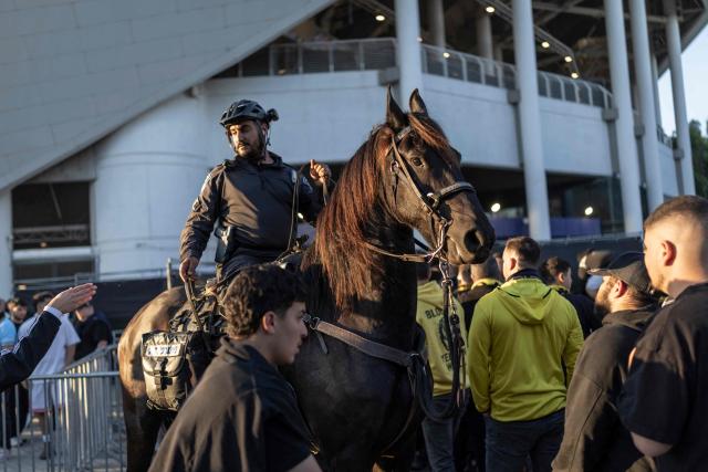 Mounted police guard an entrance as Beitar Jerusalem fans attempt to enter the stadium without tickets ahead of a match against Hapoel Tel Aviv at Bloomfield Stadium in Tel Aviv on May 6, 2026. (Photo by Ilia YEFIMOVICH / AFP)
