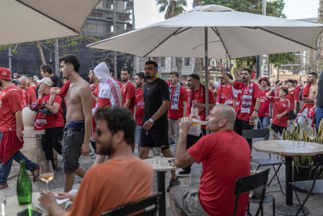 Hapoel Tel Aviv fans head to the stadium ahead of the last-season derby match against Maccabi Tel Aviv on their way to Bloomfield Stadium in Tel Aviv on May 9, 2026. (Photo by Ilia YEFIMOVICH / AFP)