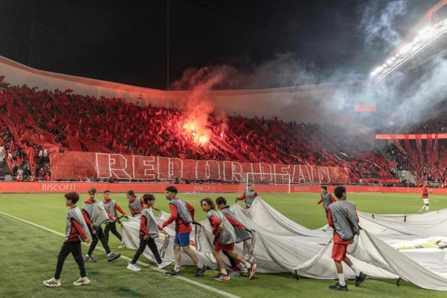 Hapoel Tel Aviv fans light pyrotechnics during the last derby match of the season against Maccabi Tel Aviv at Bloomfield Stadium in Tel Aviv on May 6, 2026. (Photo by Ilia YEFIMOVICH / AFP)