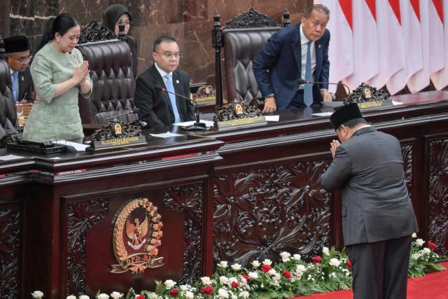 Indonesian President Prabowo Subianto (R) greets House of Representatives (DPR) Speaker Puan Maharani before delivering a speech on the macroeconomic framework to lawmakers at the Parliament building in Jakarta on May 20, 2026. (Photo by BAY ISMOYO / AFP)