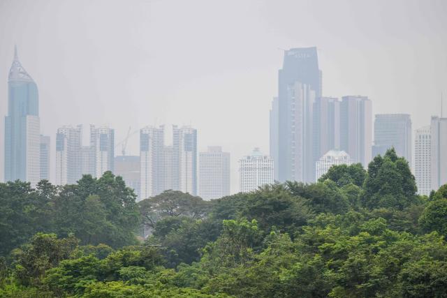 Skyscrapers are seen shrouded in haze in Jakarta on May 20, 2026. (Photo by BAY ISMOYO / AFP)
