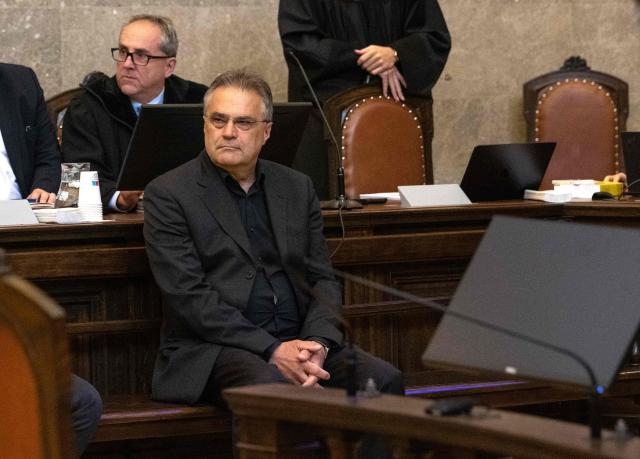 Austrian former intelligence official Egisto Ott (sitting in foreground) has taken his seat to attend a session of his trial at the criminal court in Vienna, Austria, where the verdict was expected on May 20, 2026. Ott is currently standing trial on a slew of charges that include handing over sensitive devices and selling secret information to Russia. Ott, who denies all the charges against him, is also accused of having passed secret information for years to Jan Marsalek, the former chief operating officer of Germany's collapsed payment processing firm Wirecard, who is suspected of working for Russia's intelligence services. (Photo by Joe Klamar / AFP)