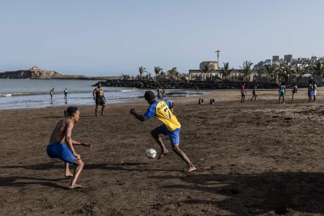 People play football at Gamboa Beach in Praia, on May 19, 2026. (Photo by PATRICK MEINHARDT / AFP)