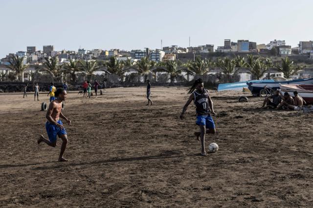 People play football at Gamboa Beach in Praia, on May 19, 2026. (Photo by PATRICK MEINHARDT / AFP)