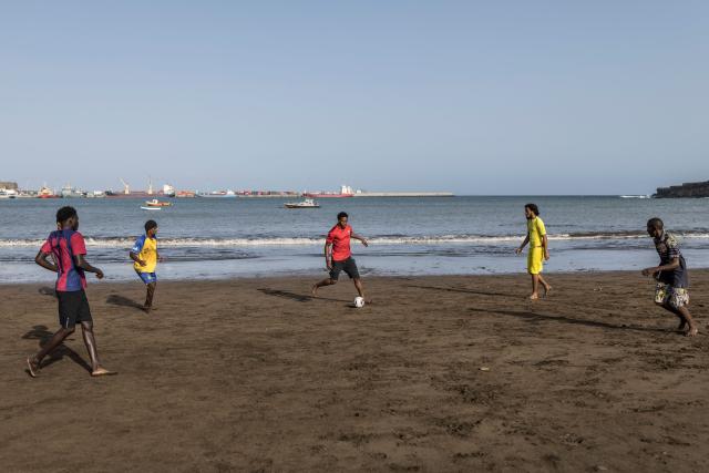People play football at Gamboa Beach in Praia, on May 19, 2026. (Photo by PATRICK MEINHARDT / AFP)