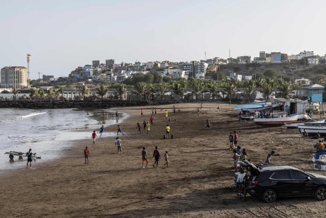 A general view of people playing football at Gamboa Beach in Praia, on May 19, 2026. (Photo by PATRICK MEINHARDT / AFP)