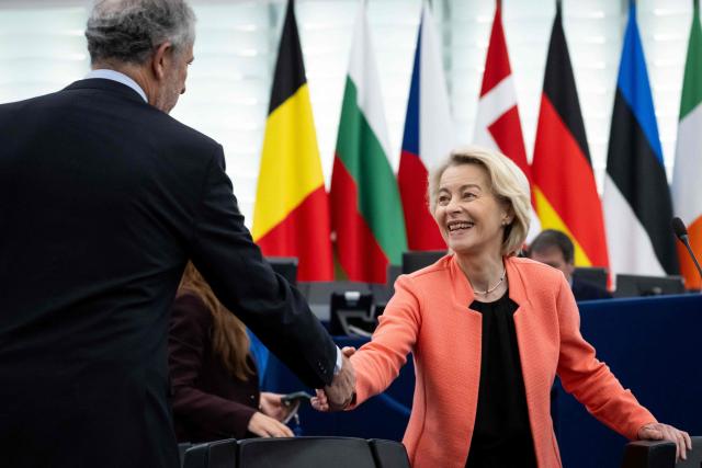 European Commission President Ursula von der Leyen (R) shakes hands with a member of the European Parliament upon arrival for a plenary session at the Strasbourg European Parliament, in Strasbourg, northeastern France, on May 20, 2026. (Photo by SEBASTIEN BOZON / AFP)
