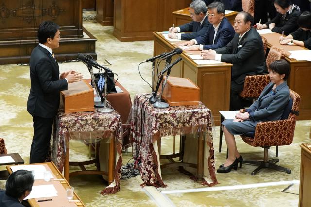 Japan's Prime Minister and President of the Liberal Democratic Party Sanae Takaichi (R) listens to questions from leader of the Democratic Party for the People (DPFP) Yuichiro Tamaki (L) during a leaders' debate at the National Diet in Tokyo on May 20, 2026. (Photo by Kazuhiro NOGI / AFP)