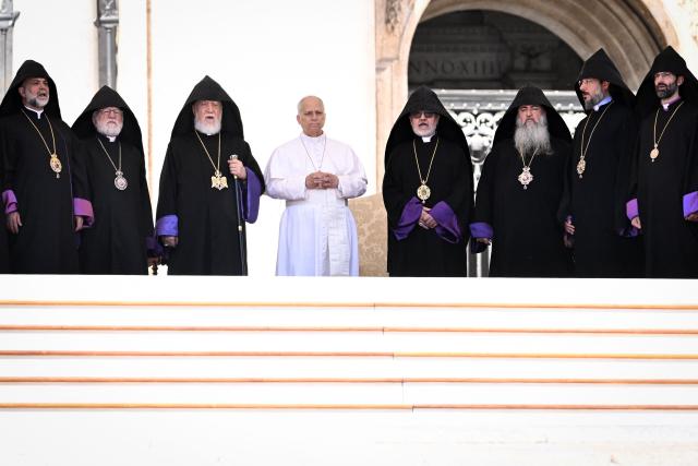 Pope Leo XIV (C) meets with Supreme Patriarch and Catholicos of All Armenians Garegin II (Karekin II) (3rd L), head of the Armenian Apostolic Church, and orthodox priests at the end of the weekly general audience at St Peter's Square in the Vatican on May 20, 2026. (Photo by TIZIANA FABI / AFP)