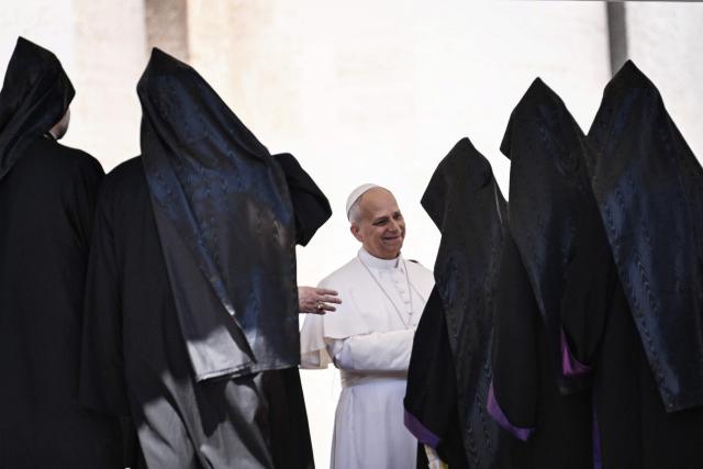Pope Leo XIV (C) meets with orthodox priests at the end of the weekly general audience at St Peter's Square in the Vatican on May 20, 2026. (Photo by TIZIANA FABI / AFP)