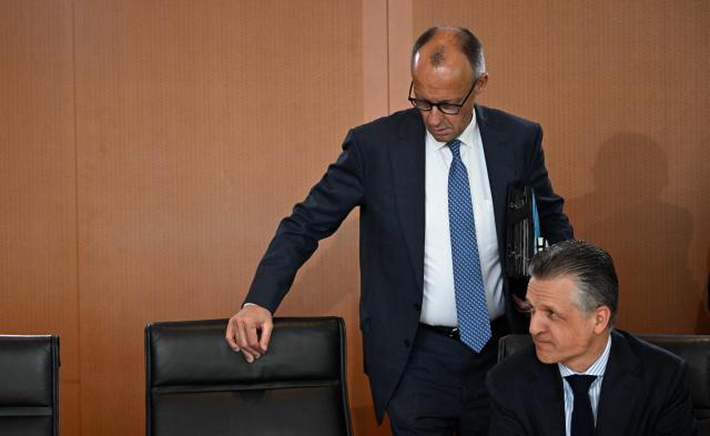 German Chancellor Friedrich Merz (L) takes his seat next to Chief of Staff and Minister for Special Tasks Thorsten Frei as he arrives to lead the weekly cabinet meeting at the Chancellery in Berlin on May 20, 2026. (Photo by Tobias SCHWARZ / AFP)