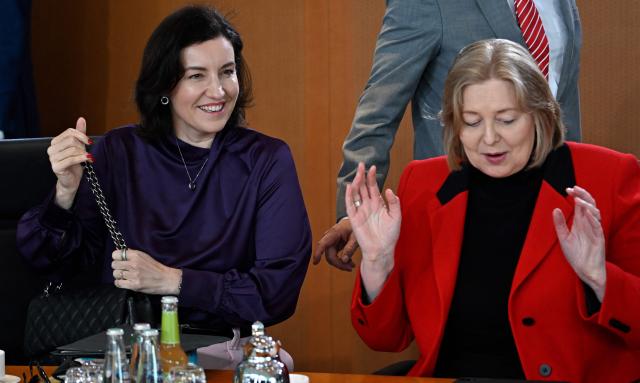German Minister for Research, Technology and Aerospace Dorothee Baer (L) and German Minister for Labour and Social Affairs Baerbel Bas share a laugh prior to the weekly cabinet meeting at the Chancellery in Berlin on May 20, 2026. (Photo by Tobias SCHWARZ / AFP)