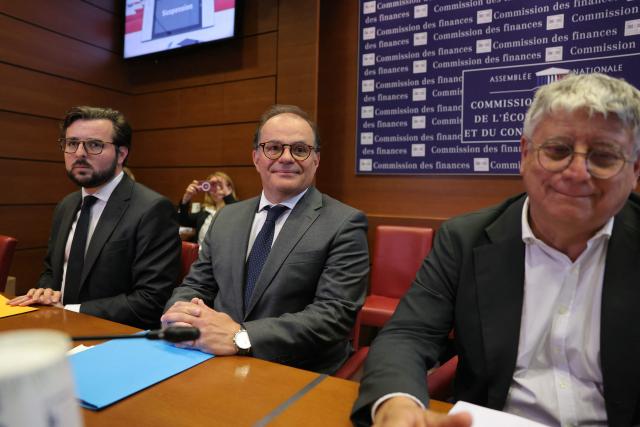 (From L)Socialistes and Apparentes' MP Philippe Brun, Former Secretary General of the French Presidency and candidate for Bank of France Governor Emmanuel Moulin and La France Insoumise - Nouveau Front Populaire's MP Eric Coquerel arrive for a hearing before the Finance Commission of the National Assembly in Paris on May 20, 2026. Moulin, a former Treasury director who has served in numerous cabinets under two former Presidents, appeared as candidate for Bank of France Governor before the Senate committee, then the National Assembly committee. The hearings will be followed by a secret ballot vote by the 121 members of both chambers. (Photo by Thomas SAMSON / AFP)