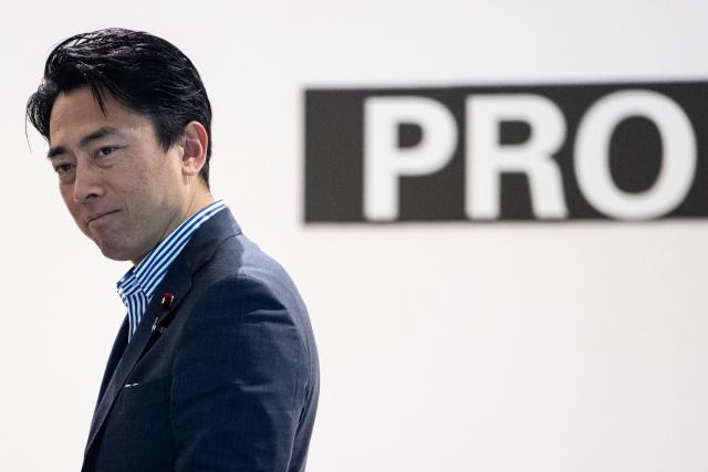 Japan's Defense Minister Shinjiro Koizumi looks at drones at the Prodrone research facility in Nagoya on May 20, 2026, as Japan pushes to expand military drone capabilities with nearly USD 850 million earmarked for unmanned defense systems in its 2026 defense budget. (Photo by ANDREW CABALLERO-REYNOLDS / AFP)
