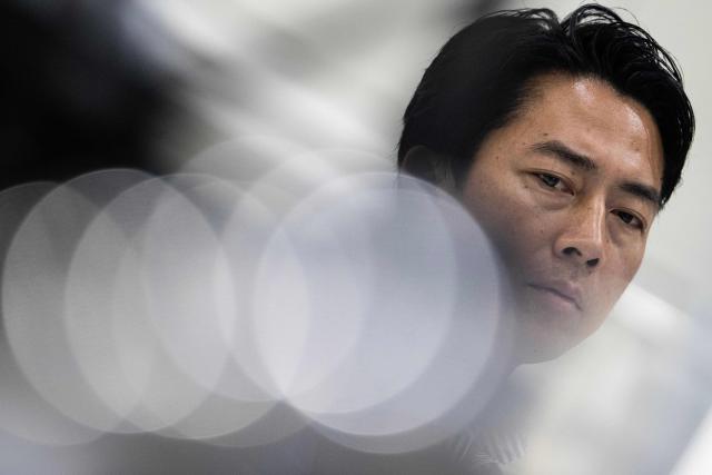 Japan's Defense Minister Shinjiro Koizumi looks at drones at the Prodrone research facility in Nagoya on May 20, 2026, as Japan pushes to expand military drone capabilities with nearly USD 850 million earmarked for unmanned defense systems in its 2026 defense budget. (Photo by ANDREW CABALLERO-REYNOLDS / AFP)