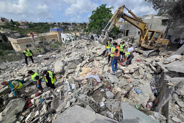 Lebanese civil defence workers search through the rubble in the southern Lebanese village of Deir Qanun al-Nahr on May 20, 2026, a day after Israeli strikes. Israeli strikes on south Lebanon killed 19 people, the health ministry said, as Hezbollah reported clashes with Israeli troops despite a truce in the war. Hezbollah drew Lebanon into the Middle East war on March 2 by firing rockets at Israel in support of its backer Iran. Since the start of the ceasefire on April 17, Israel has continued to launch strikes, carry out demolitions and issue evacuation orders in south Lebanon, saying it is targeting Hezbollah. (Photo by KAWNAT HAJU / AFP)