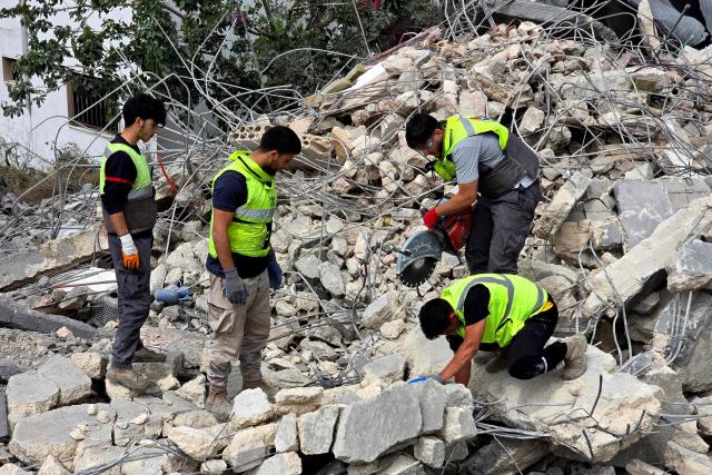Lebanese civil defence workers search through the rubble in the southern Lebanese village of Deir Qanun al-Nahr on May 20, 2026, a day after Israeli strikes. Israeli strikes on south Lebanon killed 19 people, the health ministry said, as Hezbollah reported clashes with Israeli troops despite a truce in the war. Hezbollah drew Lebanon into the Middle East war on March 2 by firing rockets at Israel in support of its backer Iran. Since the start of the ceasefire on April 17, Israel has continued to launch strikes, carry out demolitions and issue evacuation orders in south Lebanon, saying it is targeting Hezbollah. (Photo by KAWNAT HAJU / AFP)