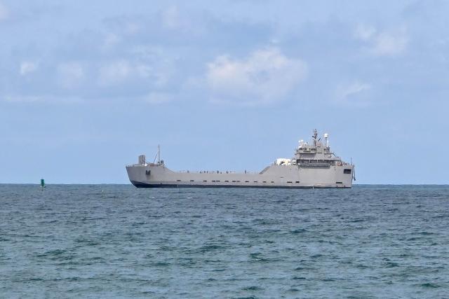 TOPSHOT - An Israeli naval vessel is motored towards the Israeli port of Ashdod, about 40 kilometres south of Tel Aviv, on May 20, 2026, after Israeli forces intercepted the Gaza-bound Global Sumud Flotilla. Israeli authorities have begun detaining hundreds of activists seized from a Gaza-bound flotilla at the southern port of Ashdod on May 20, a rights group said, after Israeli forces intercepted their vessels at sea. The Global Sumud Flotilla set sail from Turkey last week in the latest attempt by activists to breach Israel's blockade of the Palestinian territory, after Israeli forces intercepted a previous convoy last month. (Photo by Nir KAFRI / AFP)