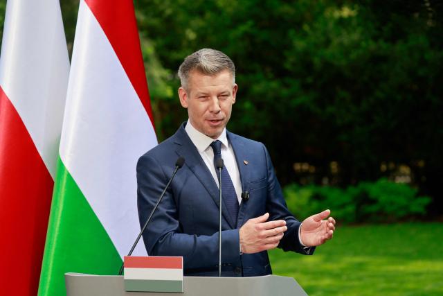 Hungary's Prime Minister Peter Magyar gestures as he holds a joint press conference with Poland's Prime Minister at the garden of the Prime Minister's residency in Warsaw, Poland, on May 20, 2026. Hungary's new Prime Minister Peter Magyar is on a two-day visit to Poland for his first official trip abroad, hoping to mark his country's re-alignment with the European Union after years of open conflict under his predecessor. (Photo by Wojtek RADWANSKI / AFP)