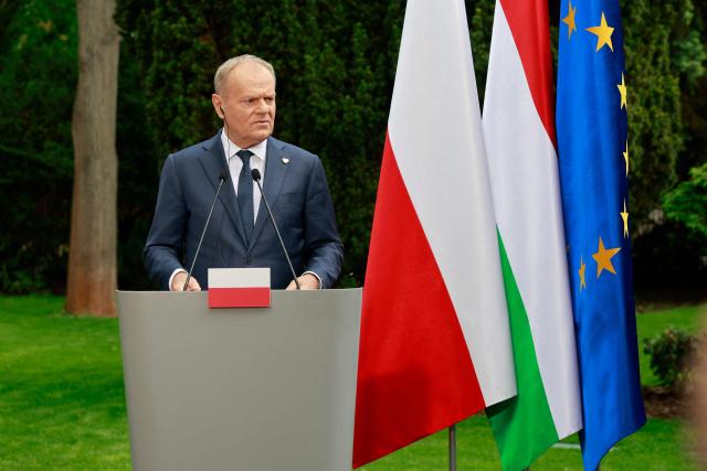 Poland's Prime Minister Donald Tusk holds a joint press conference with Hungary's Prime Minister at the garden of the Prime Minister's residency in Warsaw, Poland, on May 20, 2026. Hungary's new Prime Minister Peter Magyar is on a two-day visit to Poland for his first official trip abroad, hoping to mark his country's re-alignment with the European Union after years of open conflict under his predecessor. (Photo by Wojtek RADWANSKI / AFP)