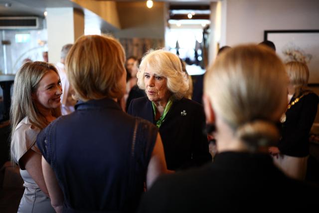 Britain's Queen Camilla talks with guests during a visit to The Parson’s Nose pub in Hillsborough, Northern Ireland on May 20, 2026, on the second day of a three-day royal visit to Northern Ireland. (Photo by Henry Nicholls / POOL / AFP)