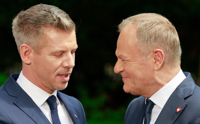 Hungary's Prime Minister Peter Magyar (L) and Poland's Prime Minister Donald Tusk are pictured at the end of a joint press conference at the garden of the Polish Prime Minister's residency in Warsaw, Poland, on May 20, 2026. Hungary's new Prime Minister Peter Magyar is on a two-day visit to Poland for his first official trip abroad, hoping to mark his country's re-alignment with the European Union after years of open conflict under his predecessor. (Photo by Wojtek RADWANSKI / AFP)