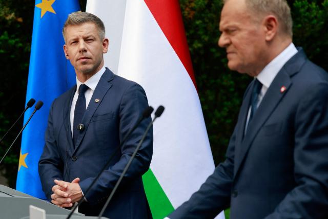 Hungary's Prime Minister Peter Magyar (L) and Poland's Prime Minister Donald Tusk (R) hold a joint press conference at the garden of the Prime Minister's residency in Warsaw, Poland, on May 20, 2026. Hungary's new Prime Minister Peter Magyar is on a two-day visit to Poland for his first official trip abroad, hoping to mark his country's re-alignment with the European Union after years of open conflict under his predecessor. (Photo by Wojtek RADWANSKI / AFP)