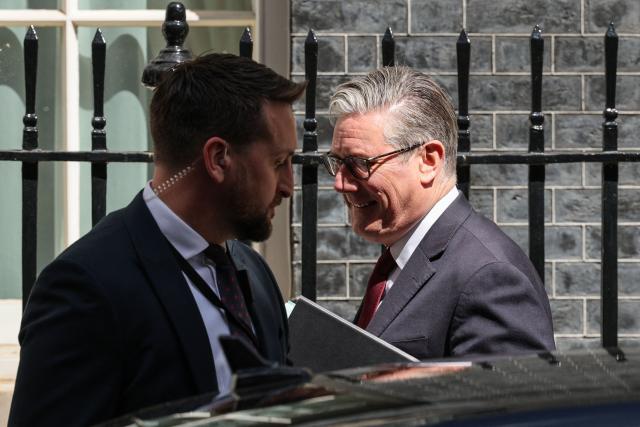 Britain's Prime Minister Keir Starmer (R) gets into a car as he leaves 10 Downing Street in central London on May 20, 2026, to take part in the weekly session of 'Prime Minister's Questions' (PMQs). (Photo by Adrian DENNIS / AFP)