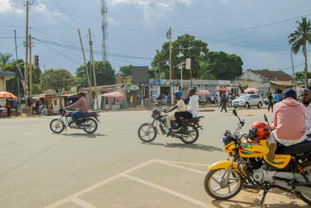 Motorcyclists ride at at a crossroad in Bunia on May 18, 2026. The World Health Organization on May 19, 2026 voiced concern about the "scale and speed" of an Ebola outbreak that has killed more than 130 people in the Democratic Republic of Congo, warning it could be lengthy. (Photo by Jorkim Jotham PITUWA / AFP)