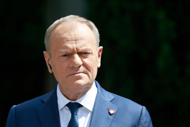 Poland's Prime Minister Donald Tusk looks on during a joint press conference with Hungary's Prime Minister at the garden of the Prime Minister's residency in Warsaw, Poland, on May 20, 2026. Hungary's new Prime Minister Peter Magyar is on a two-day visit to Poland for his first official trip abroad, hoping to mark his country's re-alignment with the European Union after years of open conflict under his predecessor. (Photo by Wojtek RADWANSKI / AFP)