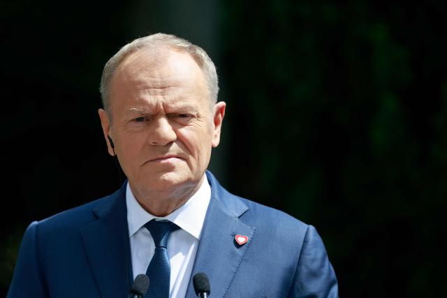 Poland's Prime Minister Donald Tusk looks on during a joint press conference with Hungary's Prime Minister at the garden of the Prime Minister's residency in Warsaw, Poland, on May 20, 2026. Hungary's new Prime Minister Peter Magyar is on a two-day visit to Poland for his first official trip abroad, hoping to mark his country's re-alignment with the European Union after years of open conflict under his predecessor. (Photo by Wojtek RADWANSKI / AFP)