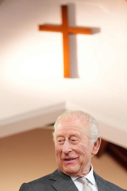 Britain's King Charles III reacts during a visit to the Pantry Foodbank at the Donard Methodist Church in Newcastle, south of Belfast, Northern Ireland on May 20, 2026, on the second day of a three-day royal visit to Northern Ireland. (Photo by Aaron Chown / POOL / AFP)