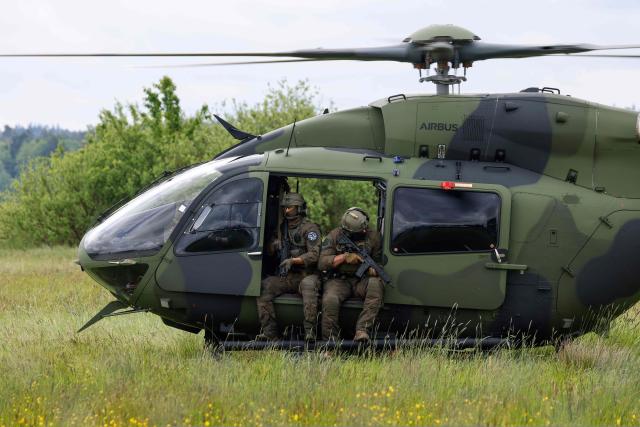A Helicopter H145M of the German Army Bundeswehr and soldiers perform for the media during the Defence Summit 2026 at Airbus Defence and Space GmbH in Manching, Bavaria, southern Germany, on May 20, 2026. (Photo by Michaela STACHE / AFP)