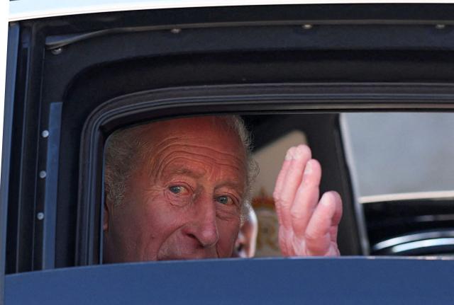 Britain's King Charles III waves as he is driven away in a car after a visit to Donard Methodist Church in Newcastle, south of Belfast, Northern Ireland on May 20, 2026, on the second day of a three-day royal visit to Northern Ireland. (Photo by Toby Melville / POOL / AFP)