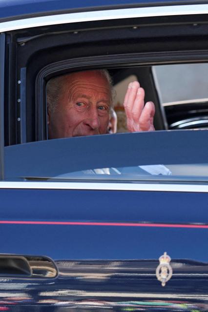 Britain's King Charles III waves as he is driven away in a car after a visit to Donard Methodist Church in Newcastle, south of Belfast, Northern Ireland on May 20, 2026, on the second day of a three-day royal visit to Northern Ireland. (Photo by Toby Melville / POOL / AFP)