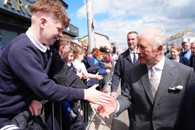 Britain's King Charles III shakes hands with young well-wishers after a visit to the Pantry Foodbank at the Donard Methodist Church in Newcastle, south of Belfast, Northern Ireland on May 20, 2026, on the second day of a three-day royal visit to Northern Ireland. (Photo by Aaron Chown / POOL / AFP)