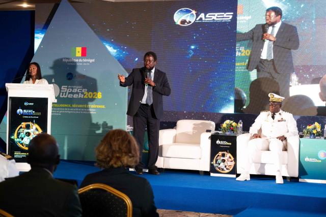 Maram Kaire (C), director of the Senegal Space Studies Agency, speaks before Rear Admiral Abdou Sene (R), Chief of Staff of the Senegal Navy, at the Senegal Space Week 2026 at a Dakar hotel on May 20, 2026. (Photo by SEYLLOU / AFP)