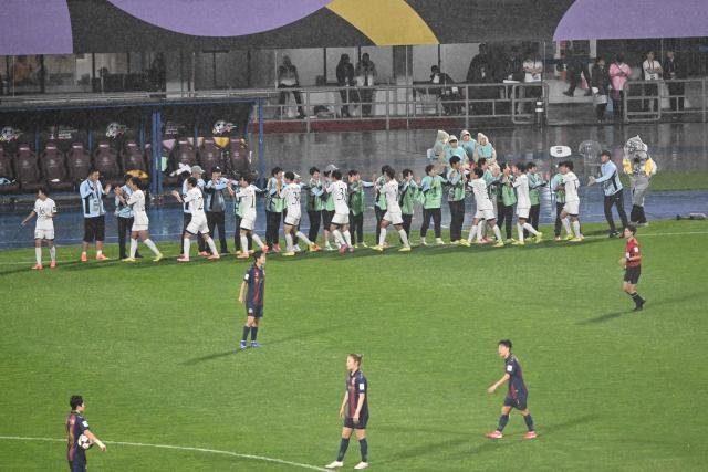 North Korea's Naegohyang Women's FC players (white) celebrate after scoring against South Korea's Suwon FC Women during the Women's Asian Champions League semi-final at Suwon Sports Complex in Suwon on May 20, 2026. (Photo by Pedro Pardo / AFP)