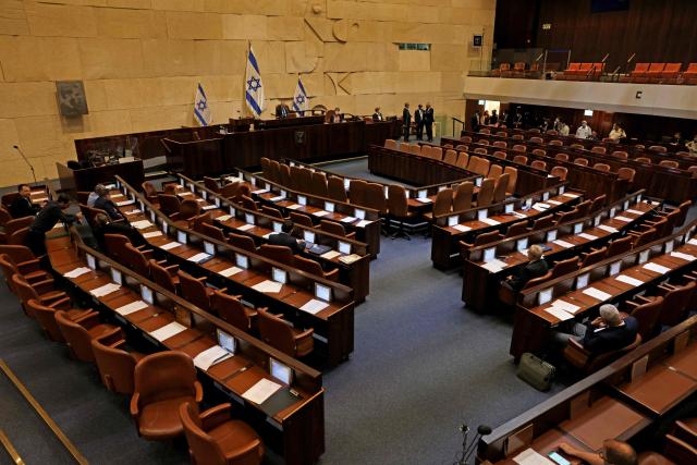 (FILES) A general view of the Knesset (Israeli parliament) in Jerusalem on June 7, 2021. Israeli lawmakers on May 20, 2026, voted to advance a bill submitted by the ruling coalition of Prime Minister Benjamin Netanyahu which would dissolve parliament and pave the way for early elections. In a preliminary reading, 110 out of 120 lawmakers voted in favour and none against, while the rest did not cast their vote. (Photo by Menahem KAHANA / AFP)