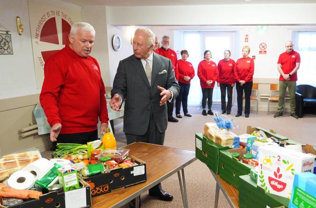 Britain's King Charles III is shown donations of food as he meets food bank volunteers during a visit to the Pantry Foodbank at the Donard Methodist Church in Newcastle, south of Belfast, Northern Ireland on May 20, 2026, on the second day of a three-day royal visit to Northern Ireland. (Photo by Aaron Chown / POOL / AFP)