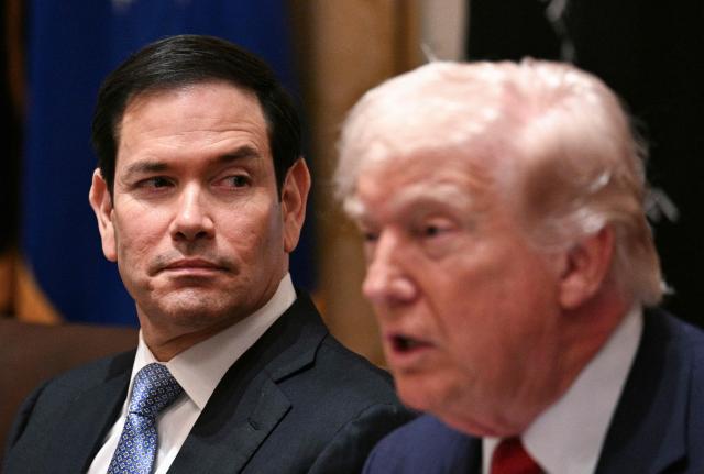 (FILES) US Secretary of State Marco Rubio listens to President Donald Trump speak during a cabinet meeting in the Cabinet Room of the White House in Washington, DC, on March 26, 2026. US Secretary of State Marco Rubio offered Cubans a "new path" in a special video address on May 20, 2026, that accused the island's communist leadership of theft, corruption and oppression. The message, in which he directly spoke to the Cuban people in Spanish, came just hours before the US Department of Justice was expected to announce a criminal indictment of former Cuban leader Raul Castro. (Photo by Jim WATSON / AFP)